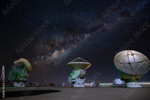 ALMA radio astronomy dishes watching the sky with milky way above