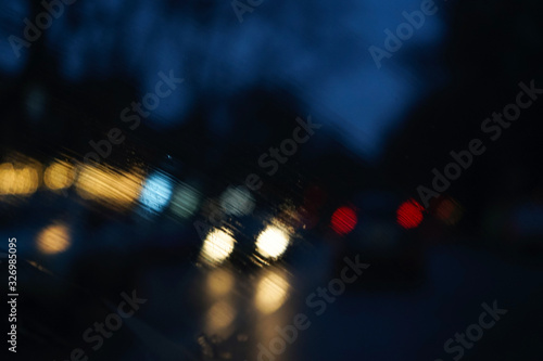 Blurry Headlight Backgrounds. Headlights of an oncoming car, blurred by rain.