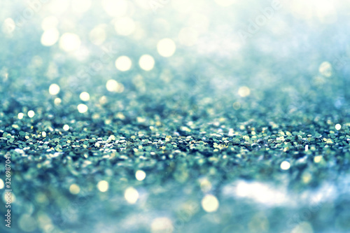 Abstract light blur blink sparkle defocus backgound. Gold and blue glitter shine dots confetti.