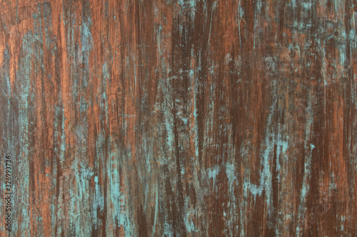 The texture of the copper background is covered with a patina