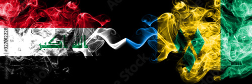 Iraq, Iraqi vs Saint Vincent and the Grenadines smoky mystic flags placed side by side. Thick colored silky smokes flags together.