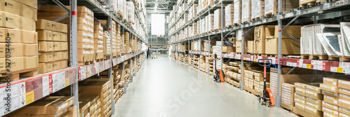 Panorama of Rows of shelves with boxes in modern warehouse