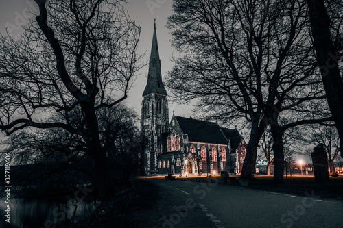 Night dusk long exposure of St Alban's Church next to Kastellet in Copenhagen, Denmark. Traditional English Anglican church consecrated in 1887 with a spire and stained glass windows.