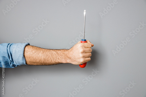 Man with screwdriver in hand stock photo