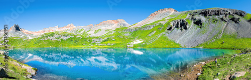 Panoramic view of turquoise vibrant Ice lake near Silverton, Colorado on summit rocky mountain peak and snow in August 2019 summer panorama