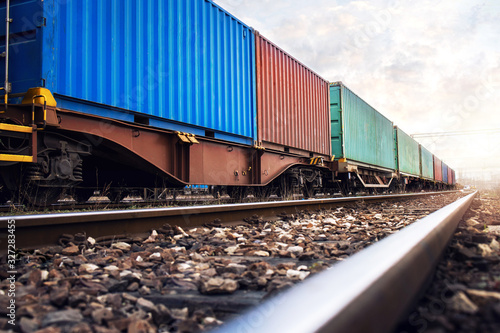 Train wagons carrying cargo containers for shipping companies. Distribution and freight transportation using railroads.