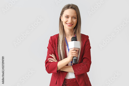 Female journalist on light background