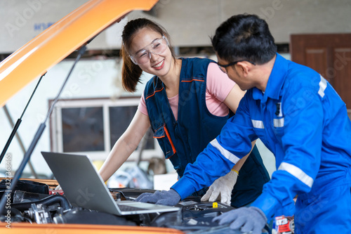 Girl engineer mechanics working on a vehicle in a garage or service workshop