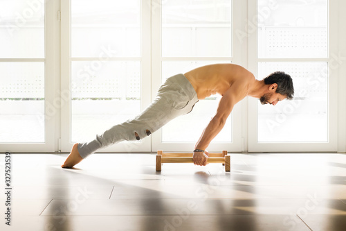 Athletic man doing a calisthenics planche pose