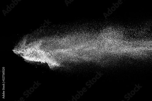 Explosion of white sand on black background.