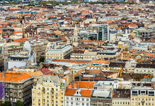 Historical downtown of Budapest, Hungary, Europe from above, aerial view. Rooftop view with old town buildings, church towers, rooftops, construction cranes. European capital city Budapest skyline.