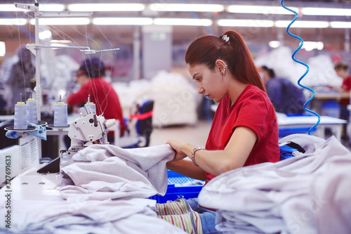 young tailor working on textile factory