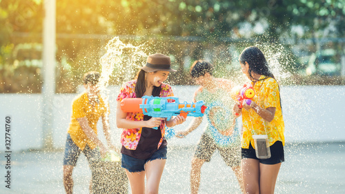 Asian people are using water guns play songkran festival in the summer april