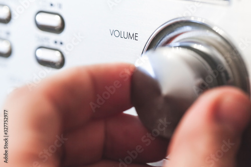 Hand on a volume control knob, close up-photo