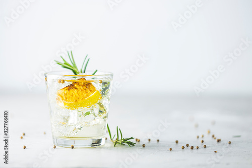 Charred Lemon, Rosemary and Coriander Gin and Tonic is a flavors are perfectly balanced refreshing cocktail. on light background, close up. Summer drinks and alcoholic cocktails