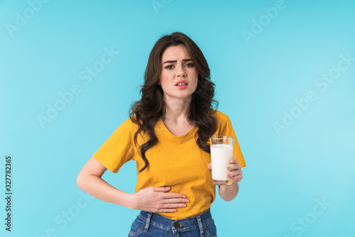 Beautiful woman with stomache holding milk.