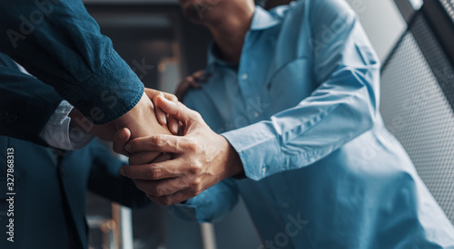 Business shaking hands, finishing up meeting. Successful businessmen handshaking after good deal.