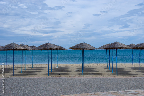 Reed umbrellas in empty beach in Peraia, of Thessaloniki, Greece