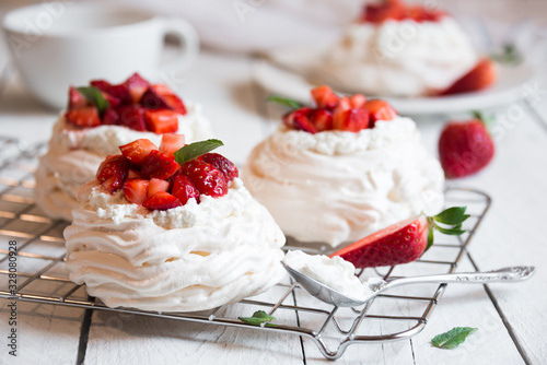 Delicious Pavlova cake with meringue and fresh strawberries