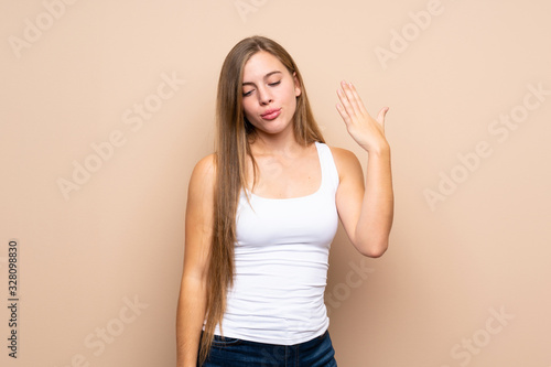 Teenager blonde girl over isolated background with tired and sick expression