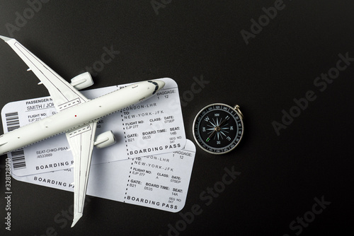 Top view of Jet airliner with boarding pass and compass. Online flight purchase, flight tickets booking, Copy space