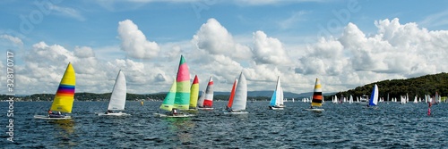 Regatta Panorama. Children Sailing small sailboats (Catamarans) with colourful sails. Australia. Commercial use image.