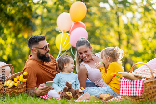 Cheerful family enjoying picnic in nature
