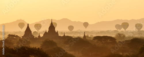 Scenic and stunning sunrise with many hot air balloons over Bagan in Myanmar. Bagan is an ancient city and World Heritage Site certified by UNESCO with thousands of historic buddhist temples