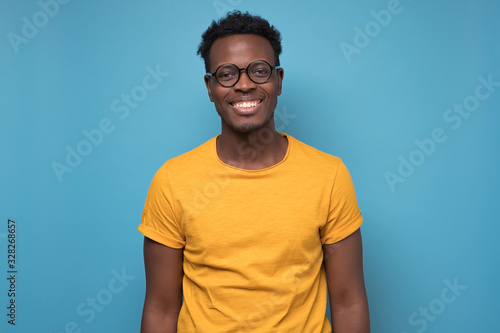 Black african american young man in yellow t-shirt with cheerful attitude