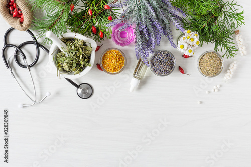 Variety of herbs and herbal mixtures as an alternative medicine concept on wooden table background top view.