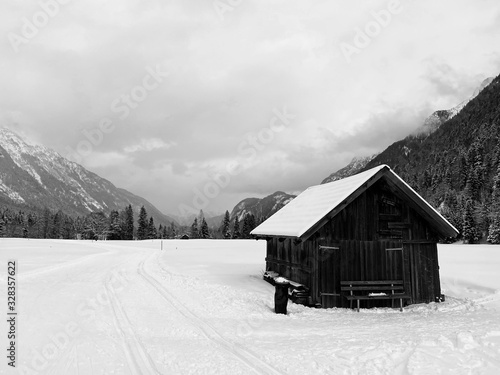 Winter mountains landscape with wooden barn Leutasch, Austria.