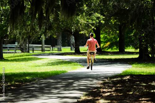 Young man riding a bike on path in HILTON HEAD ISLAND SC. 