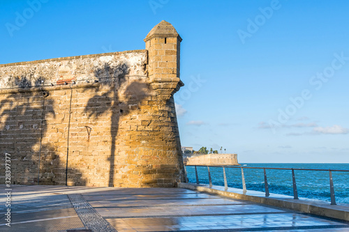 Bastion of the San Carlos Wall with the shadow of palm trees in Cadiz, Spain