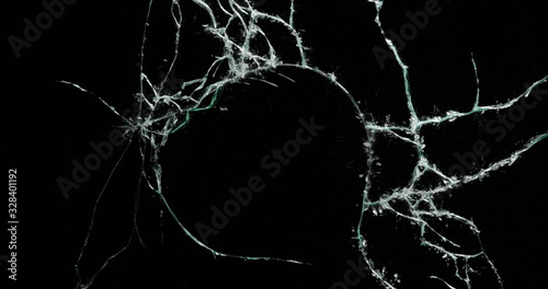 Broken cracks glass fracture effect texture isolated abstract black background. Bullet cracked window with big hole screen mirror weapon shot.