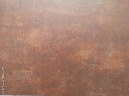 Copper color paint on cement wall has gray color and smooth surface texture concrete material background