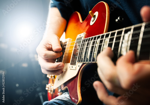 man playing on guitar close up view