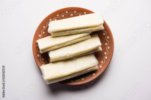 Pootharekulu is a popular recipe originated from Andhra Pradesh, India.It is a paper-thin sweet or dessert made from rice start/gram flour, jaggery/sugar and clarified butter. Served in a plate.