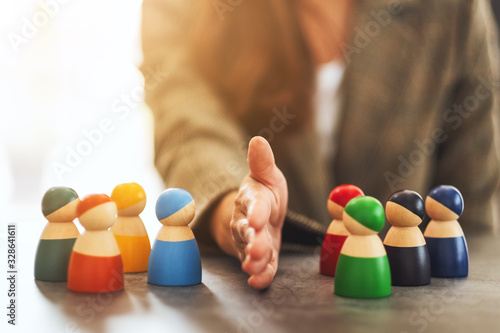 Concept image of a business woman separate wooden people into two group