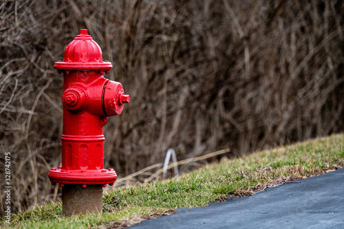 red fire hydrant next tp blacktop at a business location with copy space.