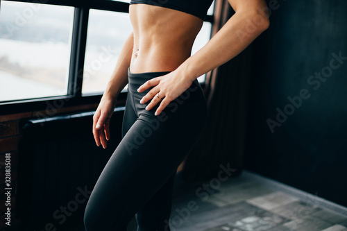 Fitness, sport and active lifestyle. Motivation. Intensive work out. Sweaty muscular body of sporty woman, close up