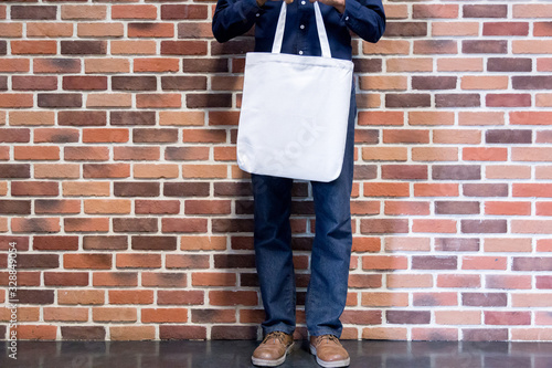 Man holding bag canvas fabric for mockup,ecology concept.