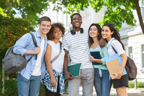 Group of international students posing in front of university