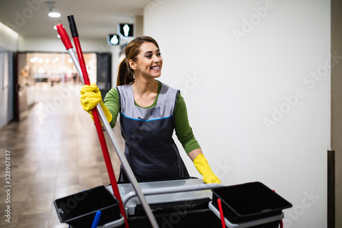 Beautiful young woman cleaning at shopping mall. Cleaning concept.