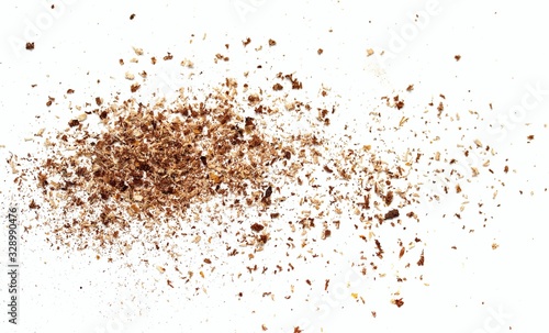 Small wooden shavings of sawdust on a white background.