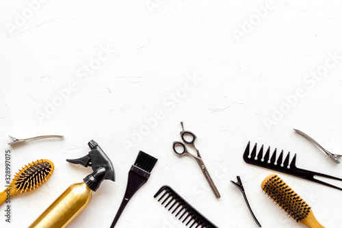 Beauty saloon accessories - combs, sciccors for hairdressing - on white background top-down frame copy space