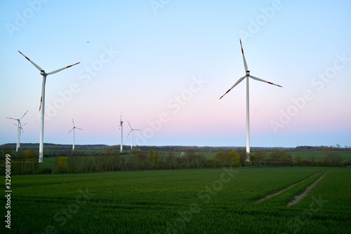 Wind turbines on countryside wind park at sunset