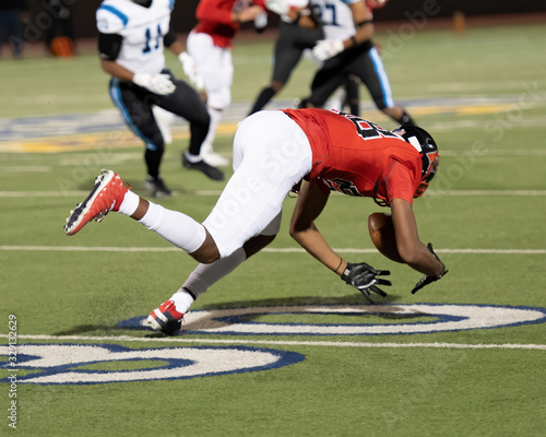 Young boy competing in a game of football