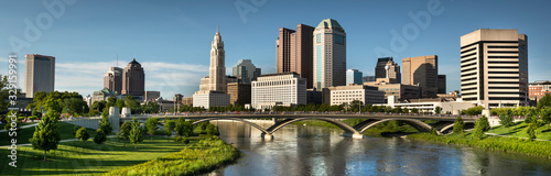 Downtown cityscape panoramic looking over the Scioto River and the Discovery Bridge along the Riverfront Park in the city of Columbus Ohio USA
