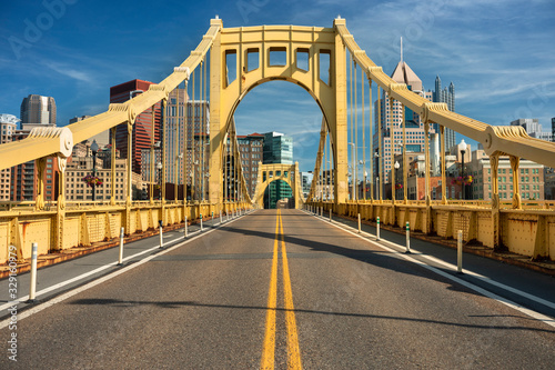 Traffic and people cross the Allegheny River on the Roberto Clemente Bridge in downtown Pittsburgh Pennsylvania USA