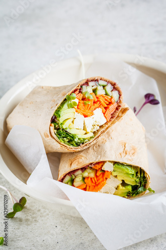 Vegan tortilla wraps with tofu, cucumber, carrots and avocado.